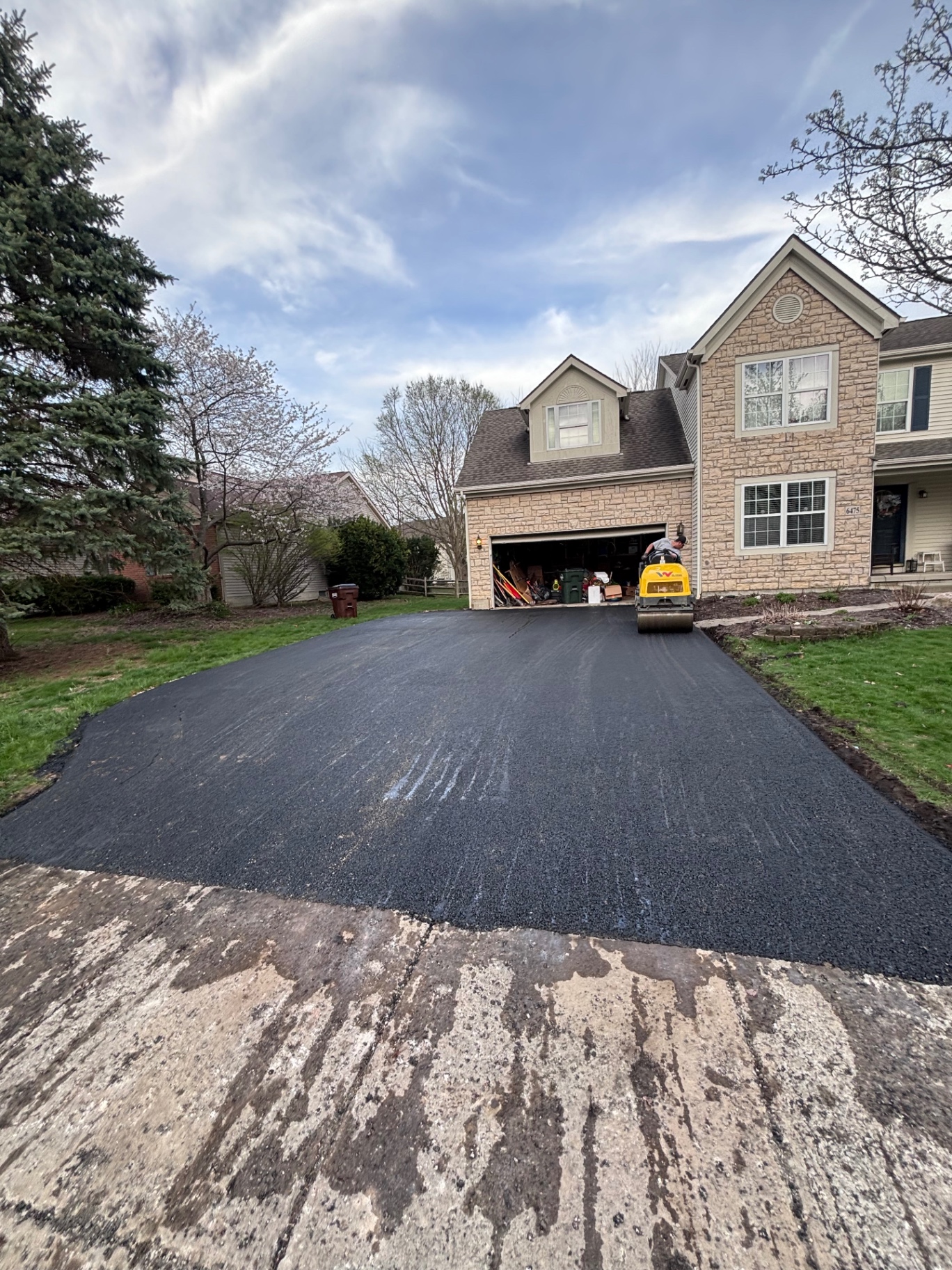 Fresh sealcoated black driveway after CrownCoat treatment